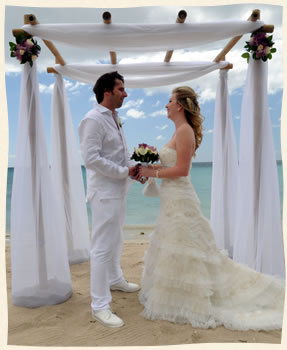Island wedding couple under bamboo arch in St. Thomas