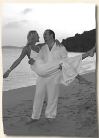 St. Thomas Bride in the arms of her groom at Bluebeards Beach
