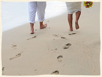 Island Wedding Couple making footprints in the sand