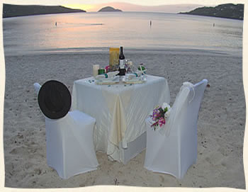 Romantic intimate beach dining after wedding.