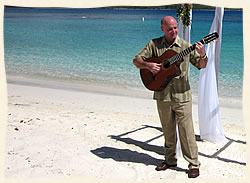 St. Thomas guitarist playing at wedding on  tropical beach.