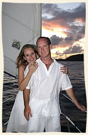 bride and groom bow of sailboat at sunset in the Caribbean Sea