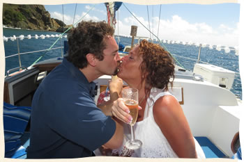 Virgin Islands kissing wedding couple on sailboat.