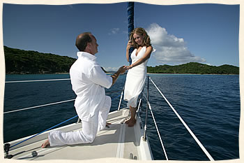Groom proposing to his bride on sailboat in the Virgin Islands.