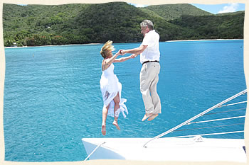 Wedding couple jumping off sailboat, St. John Virgin Islands