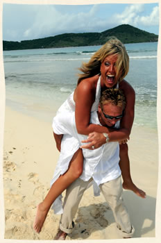 Beach bride piggy back on groom at Lindquist Beach St Thomas.