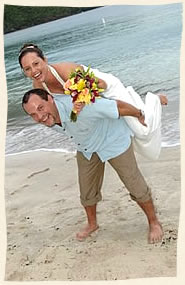 Bride on piggy back of her island groom on Magens Beach, st. Thomas