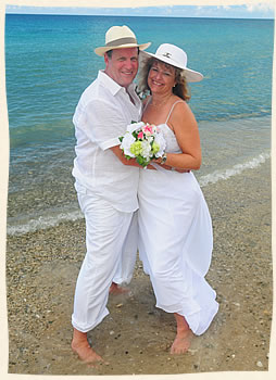 Beach cowboy and cowgirl at tropical island beach wedding.