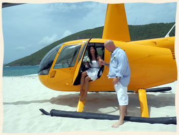 Wedding couple strolling down Lindquist Beach on St. Thomas US Virgin Islands after their wedding.