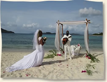 Groom serenading beach bride with guitar at Lindquist Beach - St. Thomas