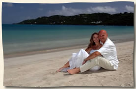 Wedding couple sitting in the sand at Magens Beach.