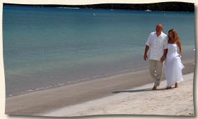 Wedding couple walking Magens Beach, St. Thomas.