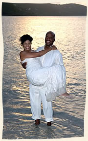 Groom swooping up bride in Magens Bay.