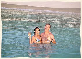 Newly weds taking the plunge after getting married on sailboat.  Virgin Islands