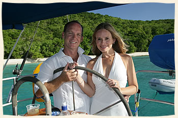 Wedding couple sailing at the helm.