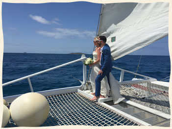 Caribbean sea wedding couple bow of boat.