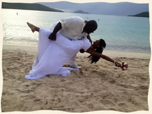 Groom dipping bride at beach wedding